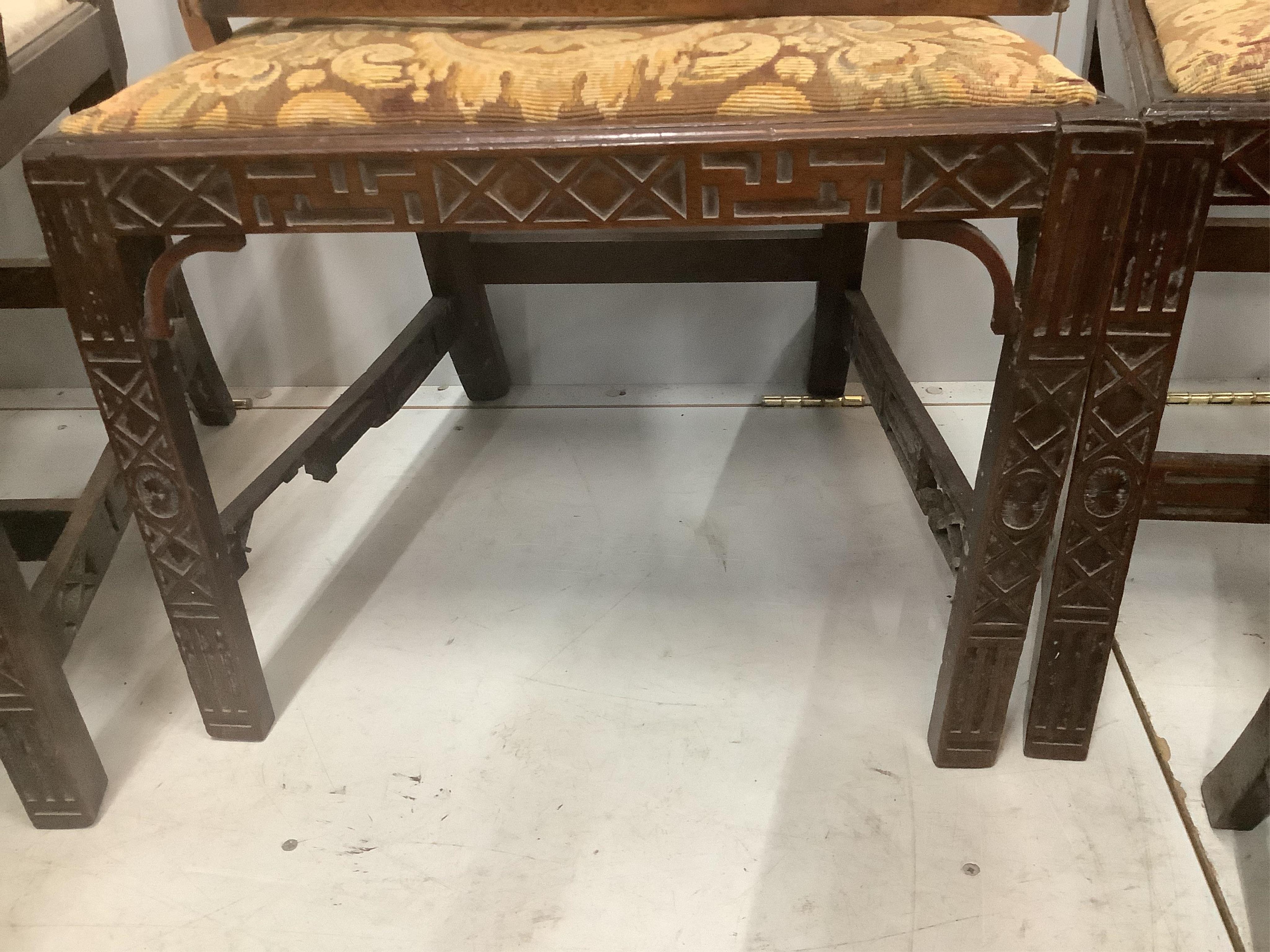 A set of six George III mahogany blind fret carved dining chairs, one with arms. Condition - poor to fair